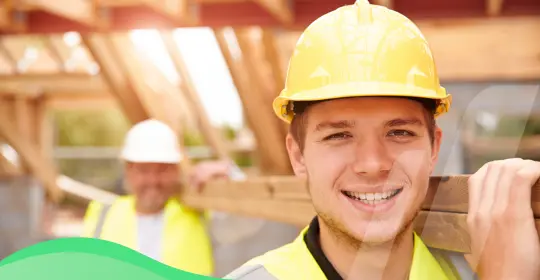 Construction Workers Carrying Materials